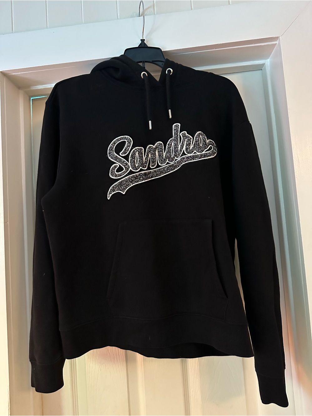 Sandro Black Off-Shoulder Hoodie Sweater with White Shimmering Script Logo